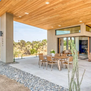 A patio with a table and chairs outside