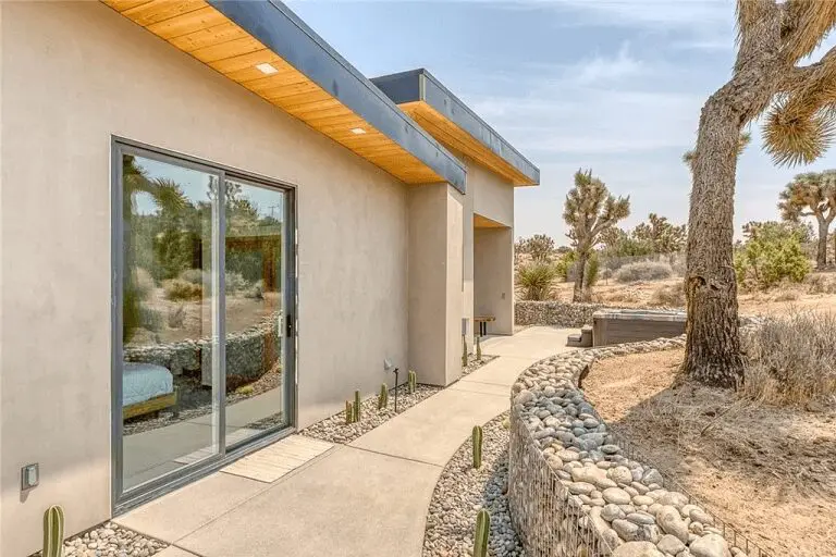 A house with a large patio and driveway.